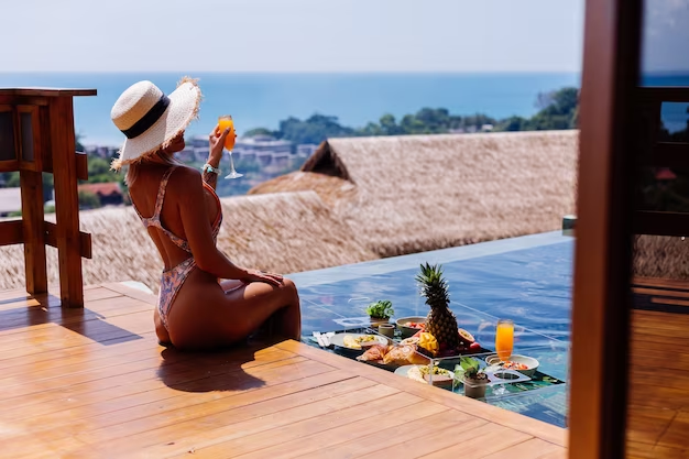 Solo traveler enjoying the stunning view from the balcony of the best place to stay in Phuket
